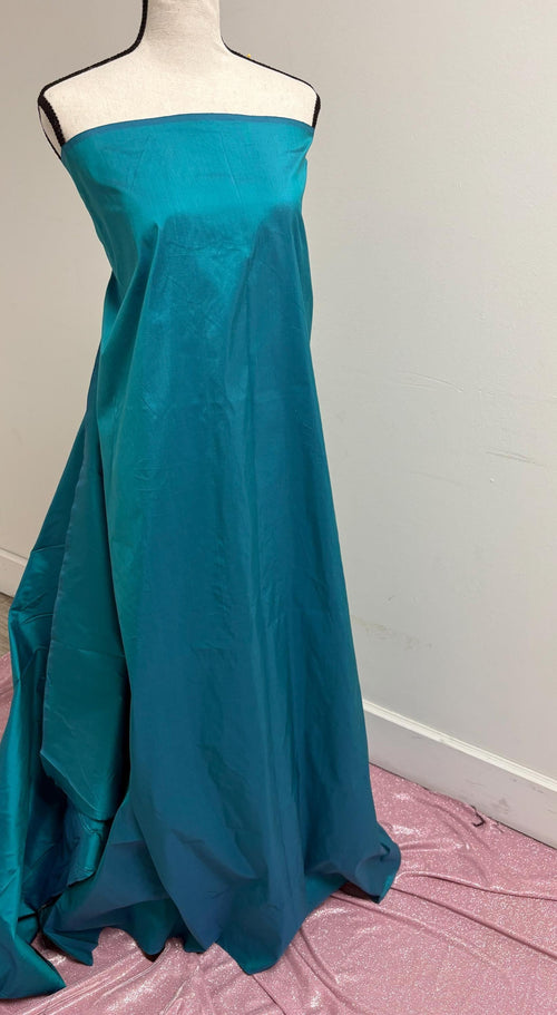 100% silk Dupioni Taffeta width 54" color is Turquoise. Machine made, fabric has slubs. Item # 10. free sample.