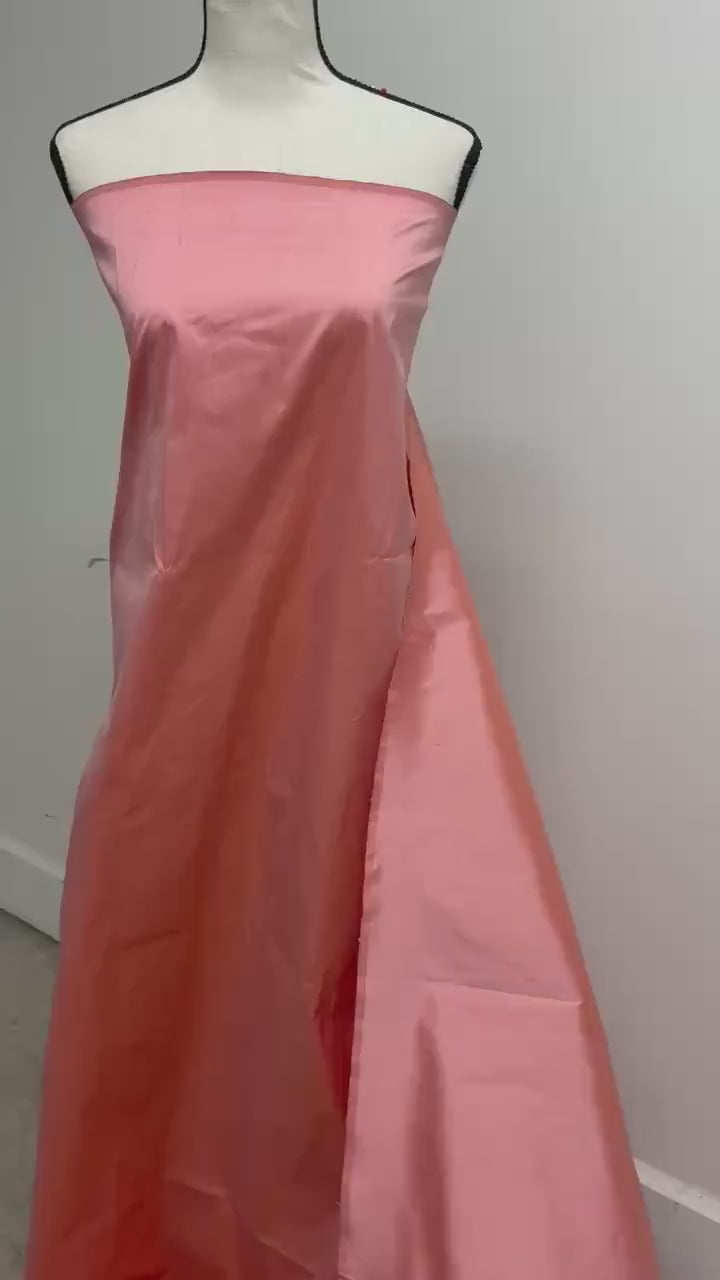 100% silk Dupioni Taffeta width 54" color is Coral. Machine made, fabric has slubs. Item # 12. free sample.