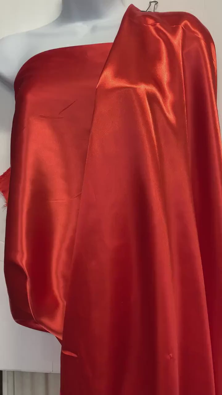 Soft silky satin fabric, width 58/60 inches 100% polyester color Coral  known as Charmeuse satin fabric suitable for lingerie and apparel.