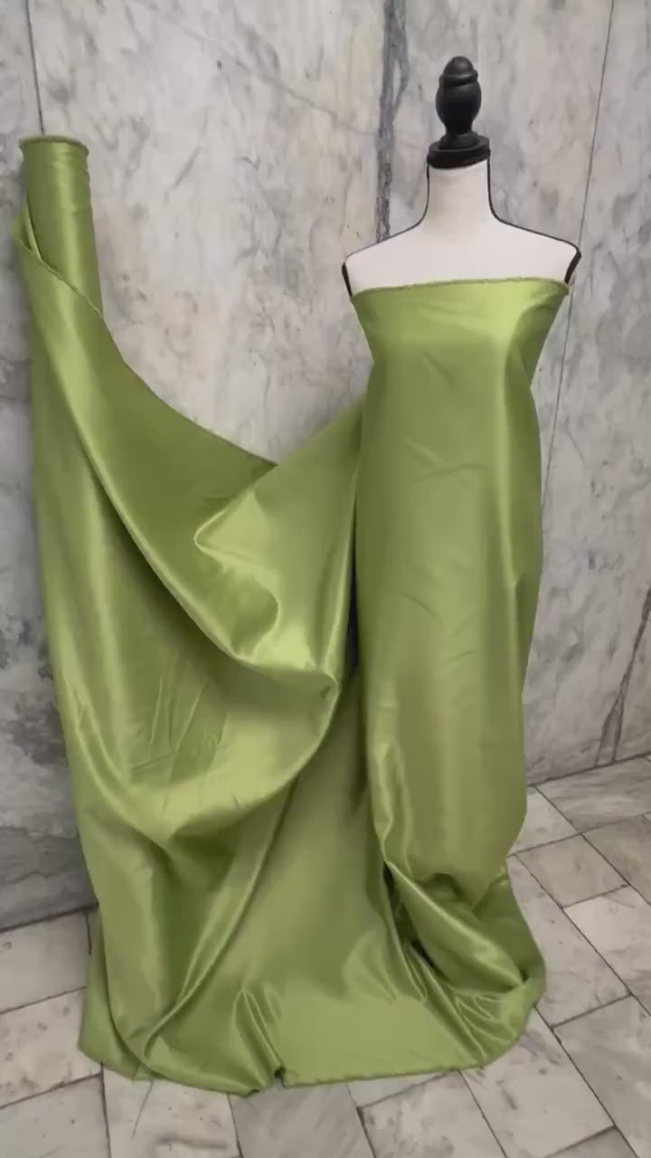 Green dull satin fabric, 58/60” wide, made of polyester – an excellent choice for gowns.
