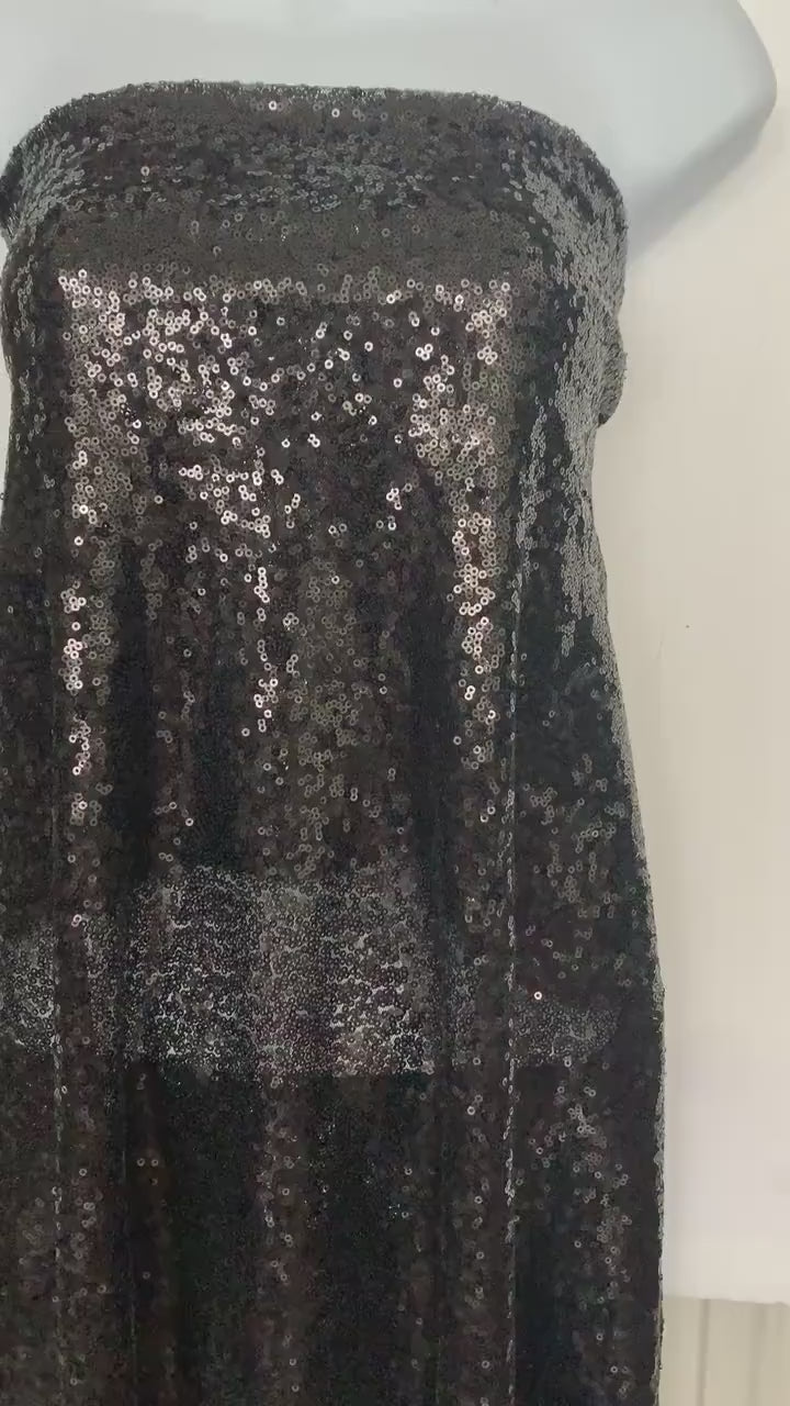 Black Sequins Mesh fabric width 56/57 inches sequins area 48 inches fabric has salvage mesh fabric on both side.