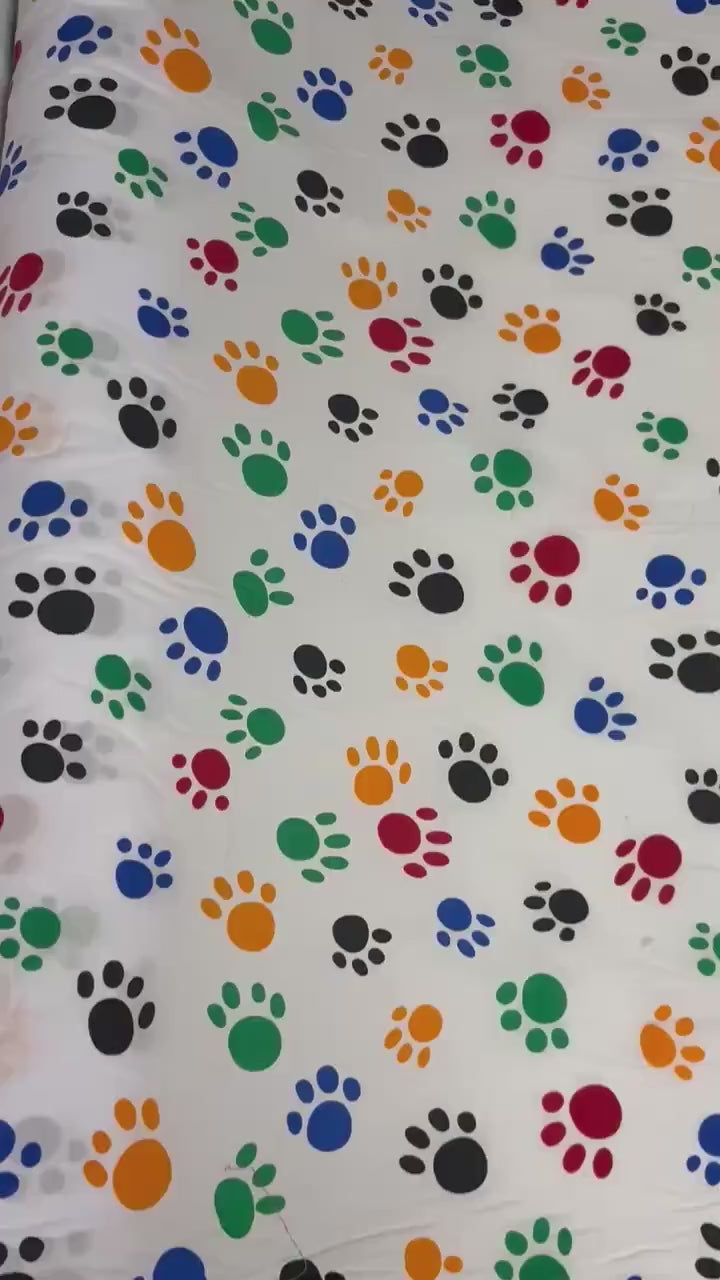A 2 yard cut Paws print fabric, width 58/60" polyester fabric in Multi color, shirt weight. kids crafts. sold by 2 yards and cut continuous.