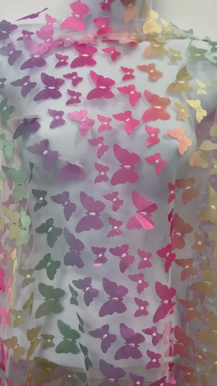 lace Butterfly on mesh design fabric. color rainbow. 60 inch width,fabric has 5 inch plain salvage on each side. butterfly are is 50 inches.