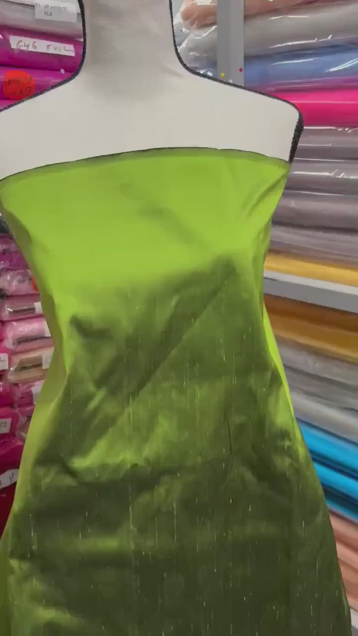 100% silk Dupioni Taffeta width 54" color is two tone Olive with black tone. Machine made, fabric has slubs. Item # 3. free sample.