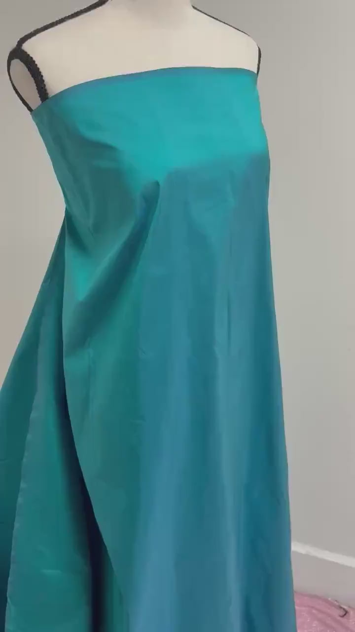 100% silk Dupioni Taffeta width 54" color is Turquoise. Machine made, fabric has slubs. Item # 10. free sample.