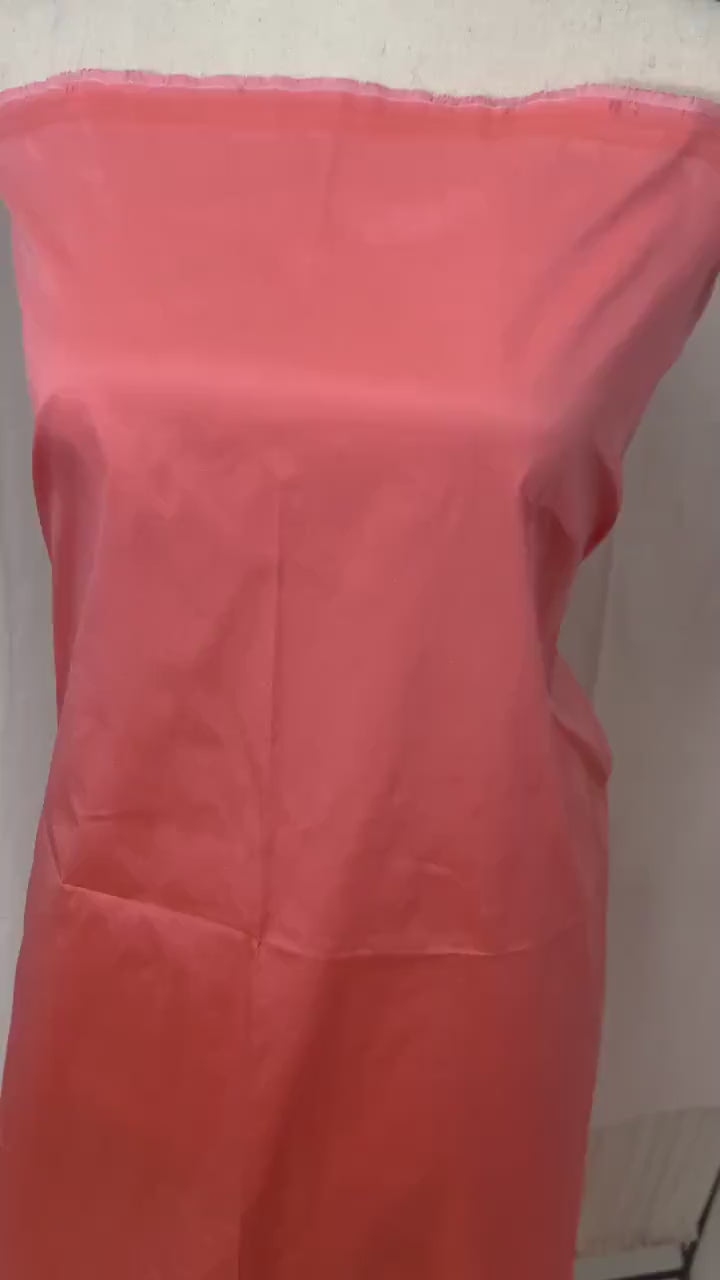 Lt. coral Taffeta fabric . Two tone fabric width 58" polyester, has a slight tone of orange and pink  shading. free sample. item 113